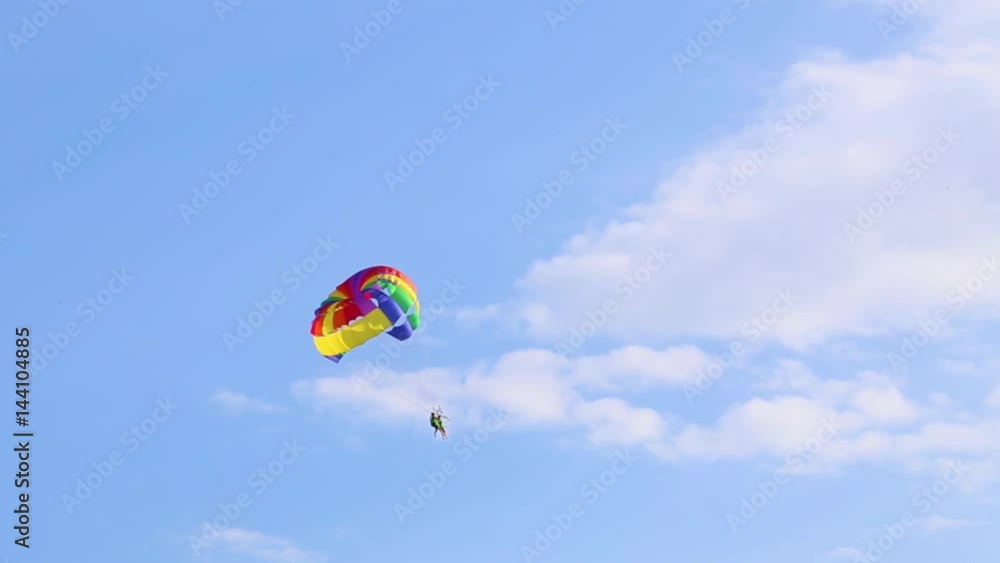 People flying with parachute in blue sky. Parasailing. Real time full hd video footage. People flying with parachute in blue sky. Parasailing. Real time full hd video footage.
