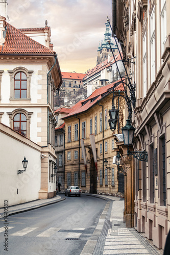 Morning in old city narrow street without people and cars in Prague.