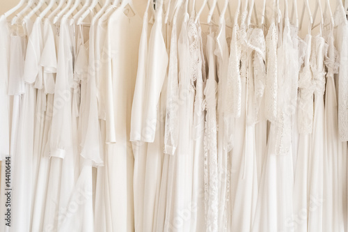 Many wedding dresses in atelier. Background