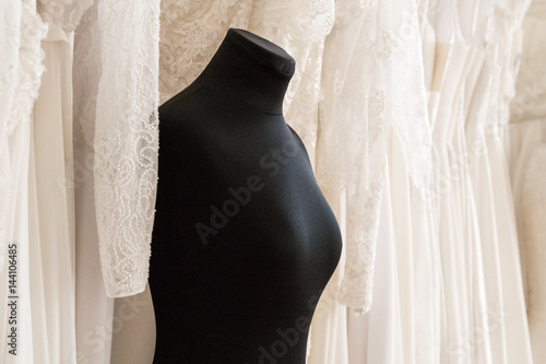 Black female mannequin on wedding dresses background