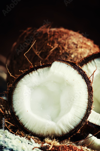 Fresh chopped coconuts on a dark background, selective focus