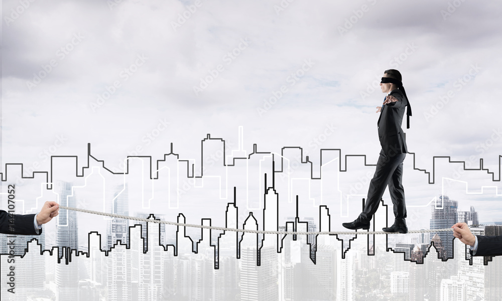 Business concept of risk support and assistance with man balancing on rope Business concept of risk support and assistance with man balancing on rope