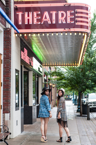 Friends looking back in sidewalk 