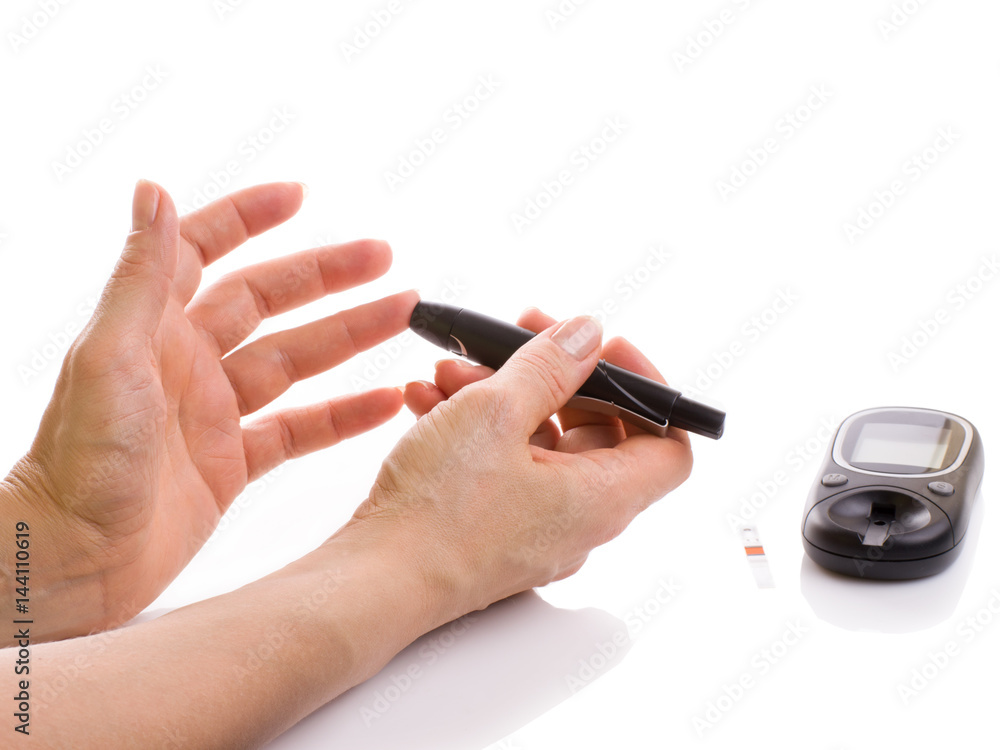 Closeup female hands using glucometer scanner Closeup female hands using glucometer scanner