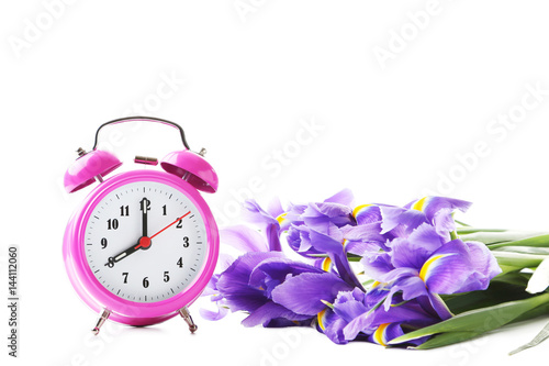 Fototapeta Naklejka Na Ścianę i Meble -  Bouquet of iris flowers with alarm clock on white background