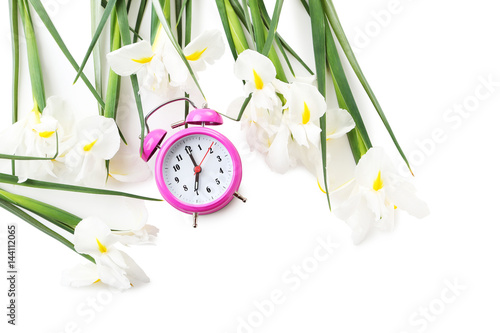 Fototapeta Naklejka Na Ścianę i Meble -  Bouquet of iris flowers with alarm clock on white background