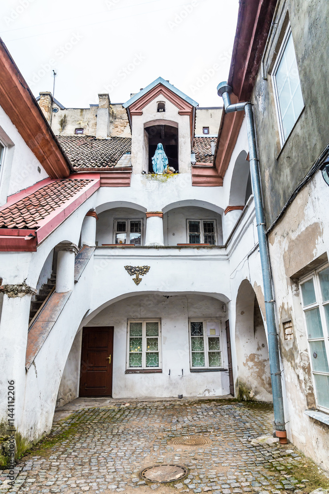 Small courtyard with a sculpture of Maria old town Vilnius Lithuania