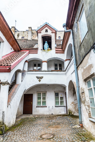 Fototapeta Naklejka Na Ścianę i Meble -  Small courtyard with a sculpture of Maria old town Vilnius Lithuania