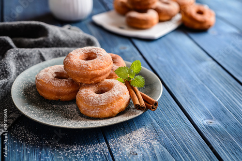 Fototapet Traditional American doughnuts with cinnamon and sugar icing