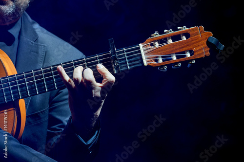 Musician playing guitar one hand for print