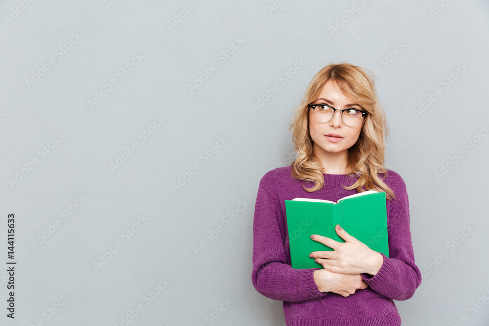 Woman with book thinking Woman with book thinking
