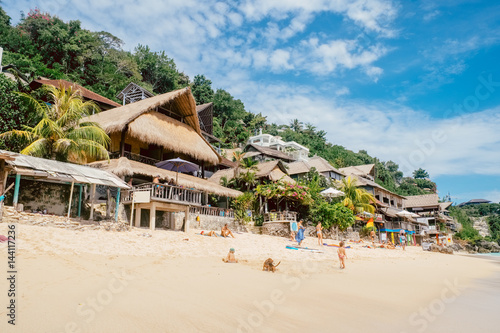Beautiful tropical sea beach village with gorgeous calm water and sunny sky on the island dream paradise of Bali nature, Indonesia landscape. Summer travel background photography
