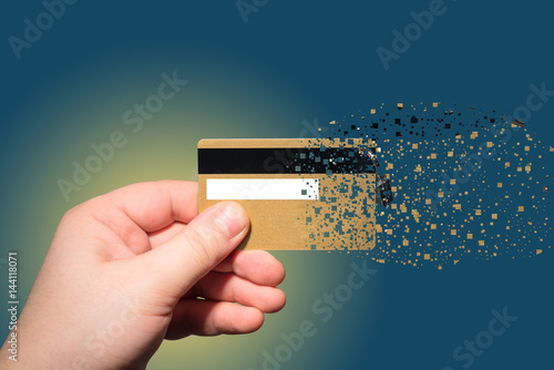 hand holding credit card which is sprayed