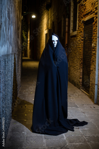 Woman in dark halloween like costume