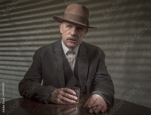 1940s mature male gangster having a drink