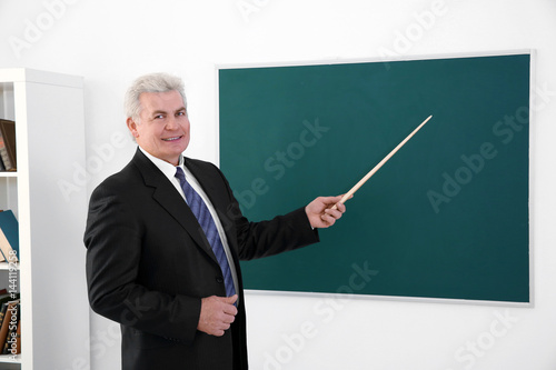 Senior teacher with pointer...
