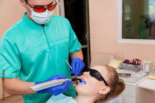 Dentist working with ultraviolet lamp