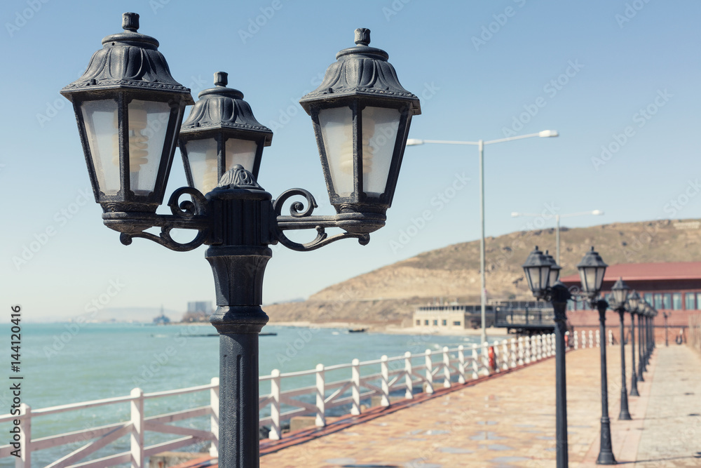 A seafront with street lights