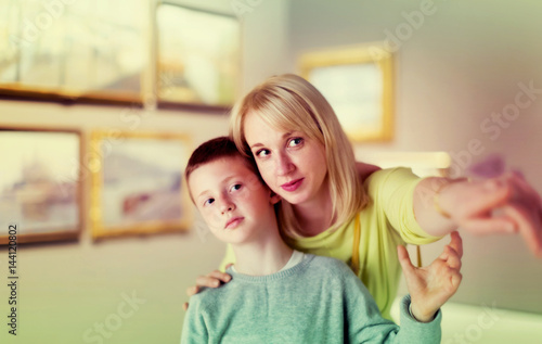 Young mom and son exploring paintings