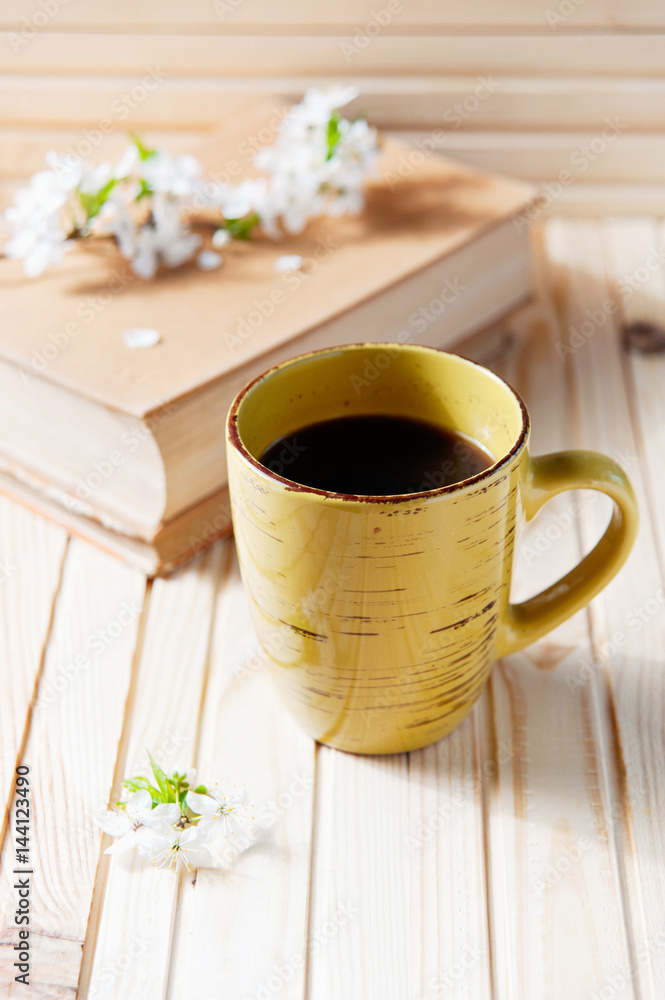 Obraz premium Romantic background with cup of tea , flowers and book over white table
