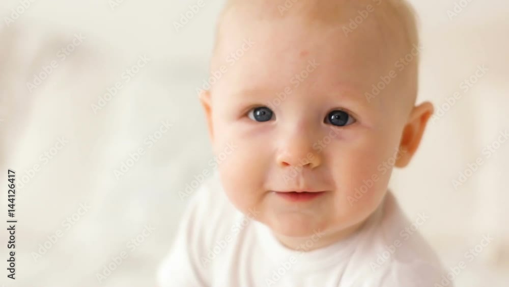 face of the little baby boy in a white t-shirt face of the little baby boy in a white t-shirt