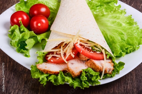 Burito with fried meat and tomatoes