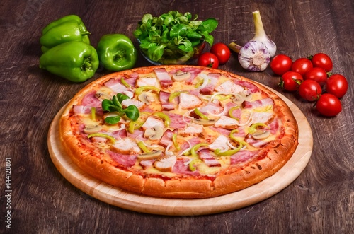 Pizza with bacon, ham, chicken and champignons