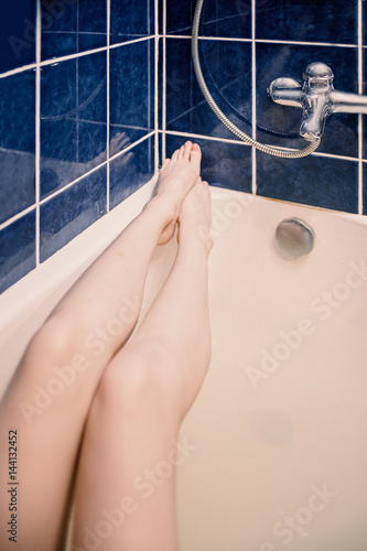 Long sexy legs of young woman taking bath. Selfie shot in warm  hipster-style color. Stock Photo | Adobe Stock