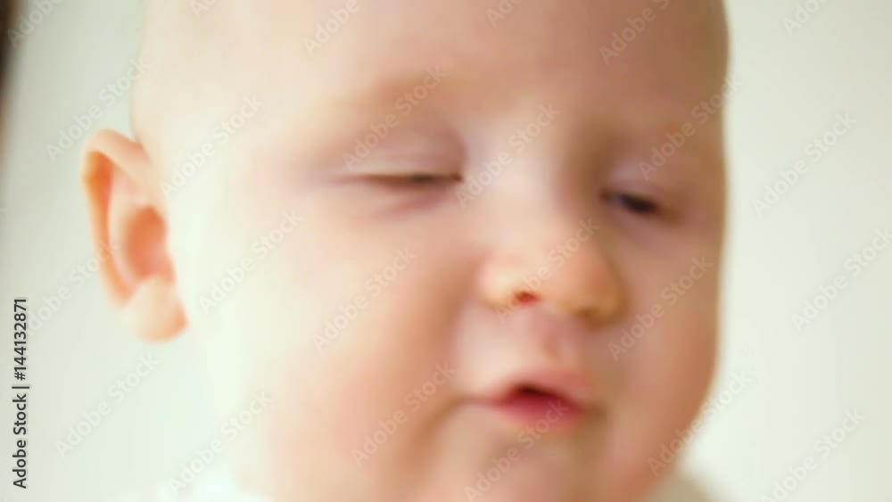 face of the little baby boy in a white t-shirt face of the little baby boy in a white t-shirt