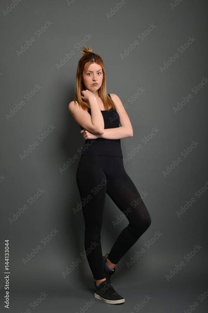 Young brunette lady posing on grey background Young brunette lady posing on grey background