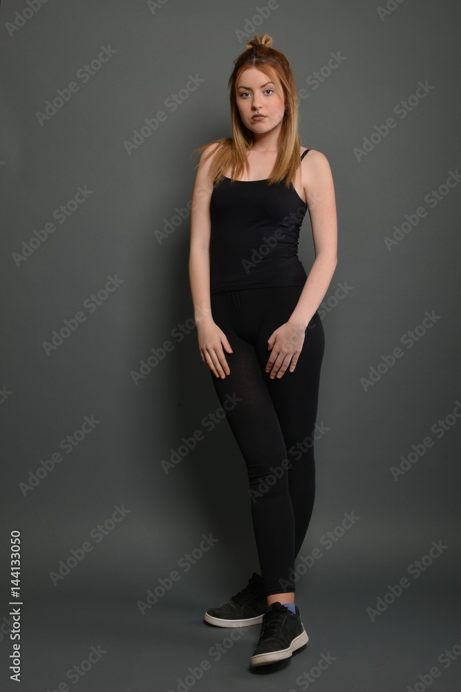 Young brunette lady posing on grey background Young brunette lady posing on grey background