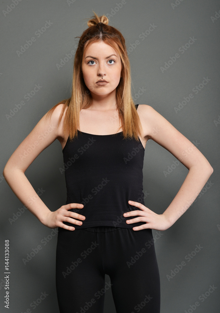 Young brunette lady posing on grey background Young brunette lady posing on grey background