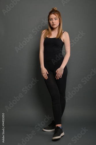 Young brunette lady posing on grey background