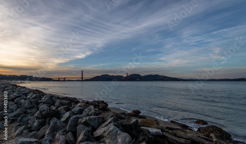 Beach and Golden Gate Bridge at sunset - San Francisco, California, USA