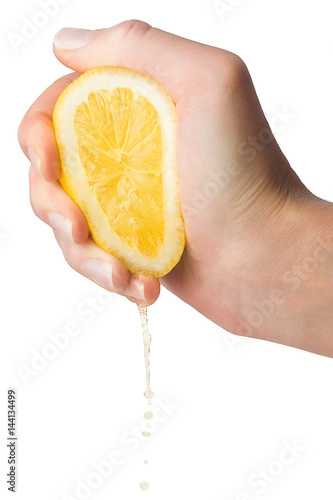 Hand squeezes lemon juice on a white background, isolated