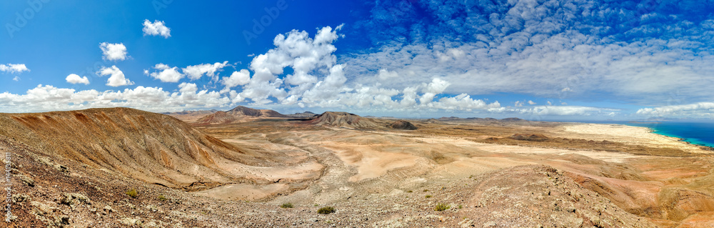 Fototapeta premium XXL panorama view of Parque Natural de Corralejo (Natural Park of Corralejo) in the northern part of Fuerteventura, Canary Islands, Spain. Seen from Montana Roja mountain. Lobos island in background.