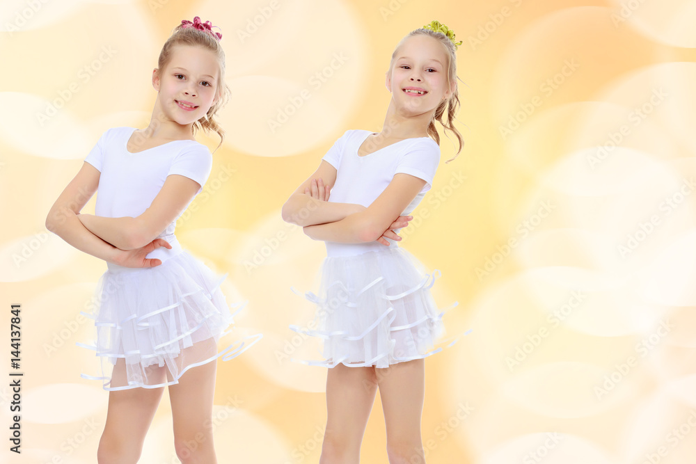 2 girls gymnast in white suits. 2 girls gymnast in white suits.