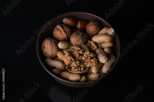 Different types of nuts are in a plate photo