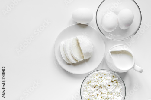 Fresh dairy products on white table background top view mockup