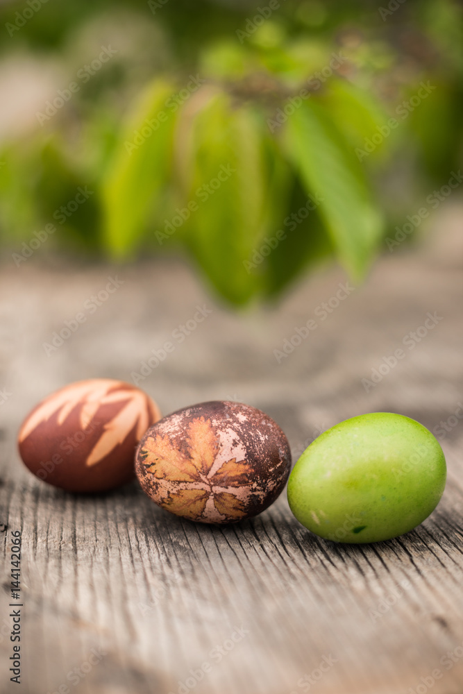 Easter eggs on rustic wooden plank