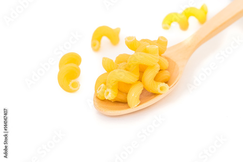 Raw Italian Macaroni Pasta  on wooden spoon. photo