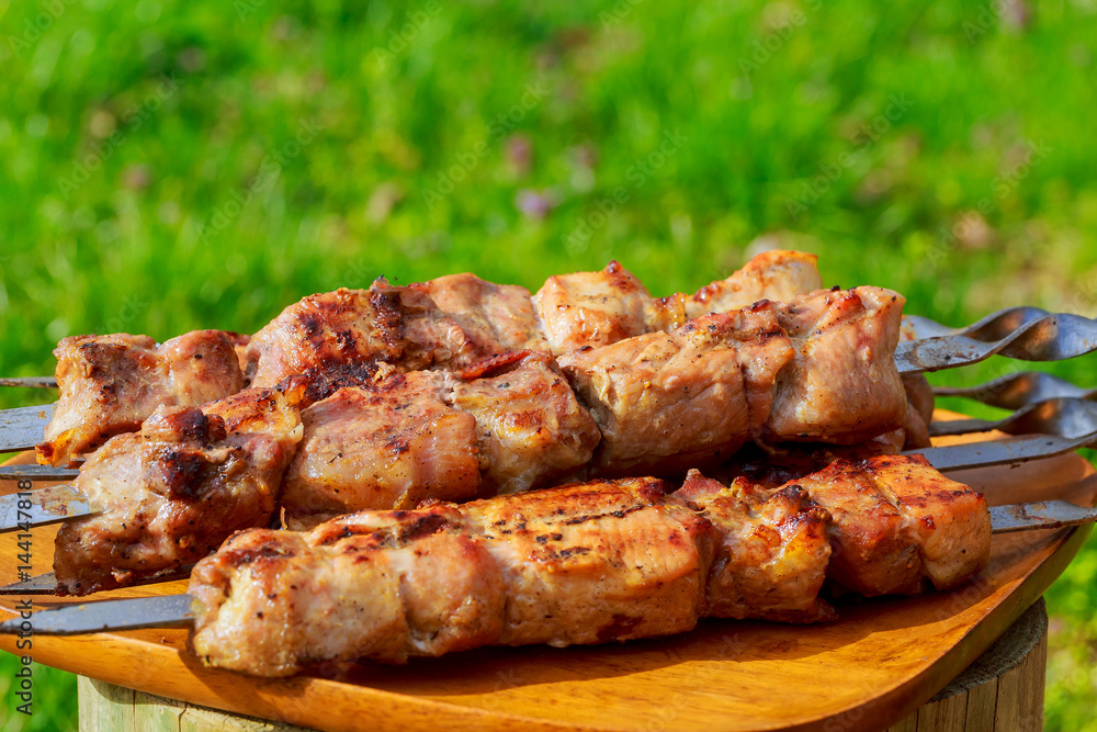 Grilled meats, hot pieces on a clay dish, selective focus