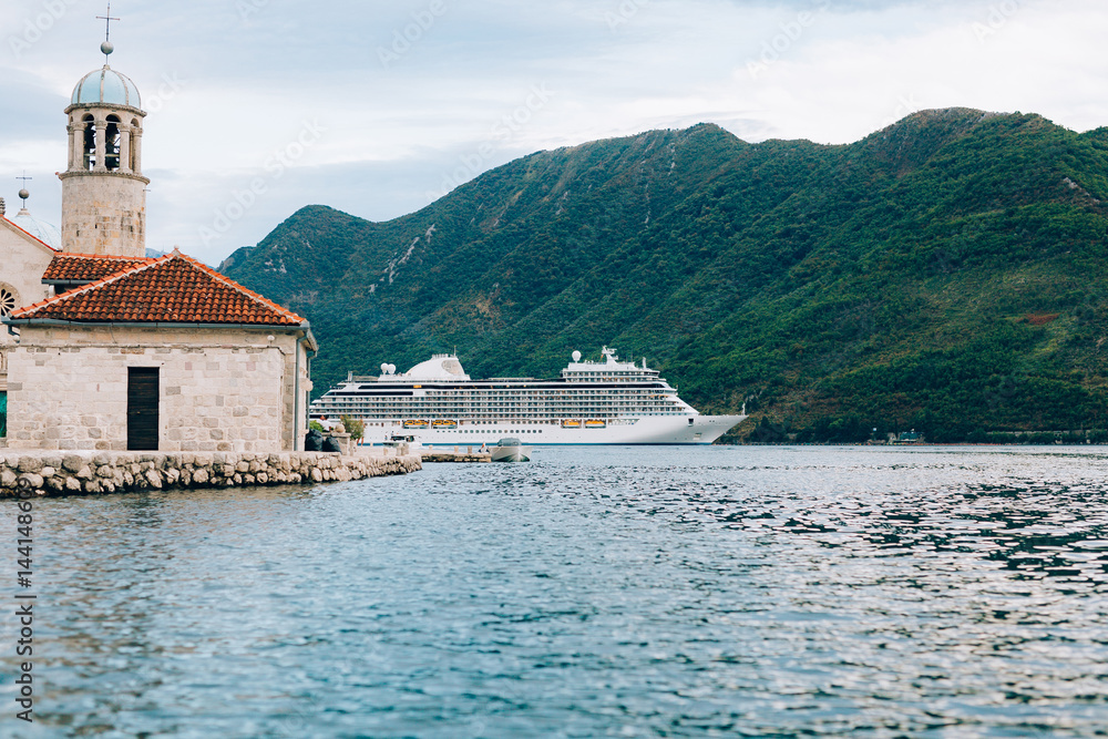 Big cruise ship in the Bay of Kotor in Montenegro. Near the island of Our Lady of the Rocks, near Perast. A beautiful country to travel.