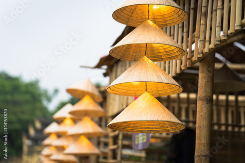 Vietnamese traditional conical hats hanging on wire for decoration.