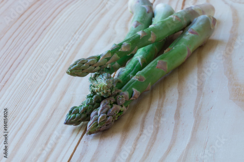 Orgarnic fresh asparagus on wooden block. photo