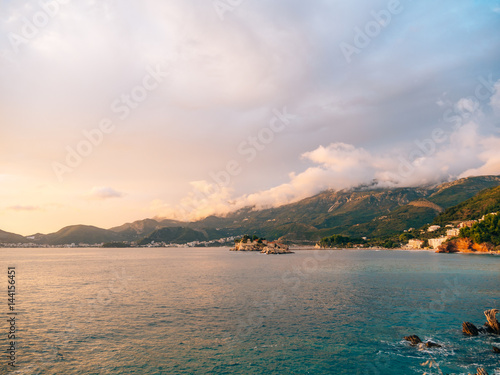 Island of Sveti Stefan, view from the beach of Crvena Glavica, at sunset. Montenegro, the Adriatic Sea, the Balkans.
