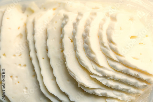 Closeup slices of brined cheese