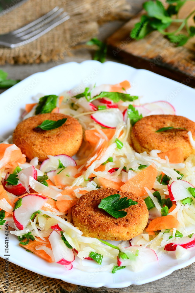 Chickpea cutlets and vegetable salad on a plate. Fried homemade chickpea cutlets. Salad made with cabbage, carrot, radish, green onions and parsley. Vegan lunch or dinner recipe. Rustic style Chickpea cutlets and vegetable salad on a plate. Fried homemade chickpea cutlets. Salad made with cabbage, carrot, radish, green onions and parsley. Vegan lunch or dinner recipe. Rustic style
