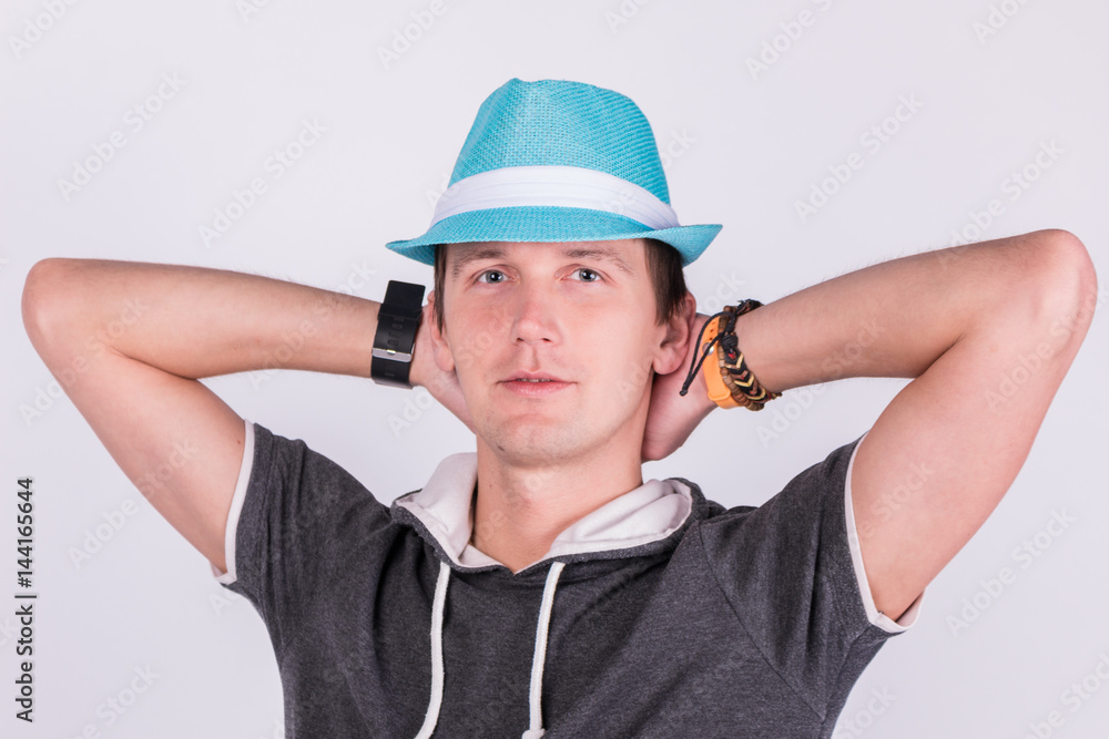 Charming handsome young man in formalwear Holds a blue hat white background Charming handsome young man in formalwear Holds a blue hat white background