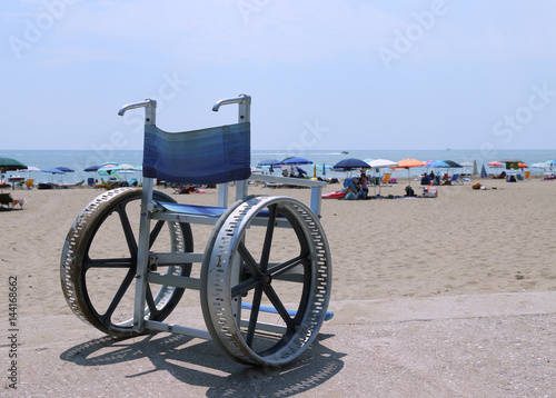 wheelchair with big steel wheels to cross the sandy beach and go